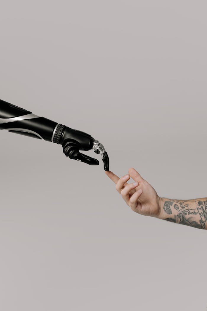 journey Close-up of a prosthetic arm and a human hand reaching towards each other in harmony.